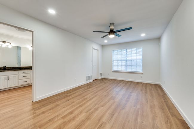 Unfurnished bedroom with light wood-type flooring, baseboards, visible vents, and recessed lighting | Image 19