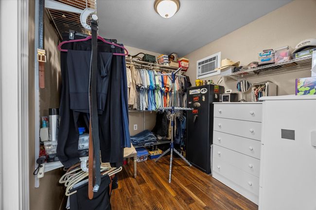 Spacious closet featuring wood finished floors and a wall mounted air conditioner | Image 16
