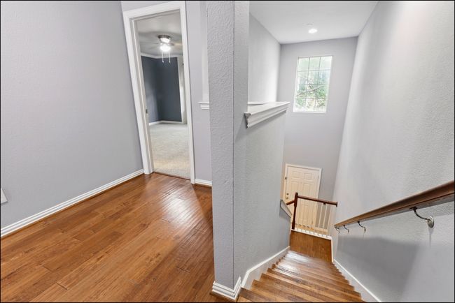 Stairway featuring baseboards, a textured wall, ceiling fan, and hardwood / wood-style floors | Image 15