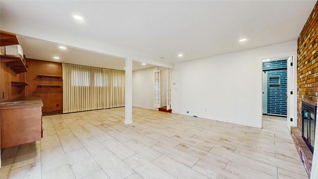 Unfurnished living room with light wood-style flooring, recessed lighting, a fireplace, and baseboards | Image 22