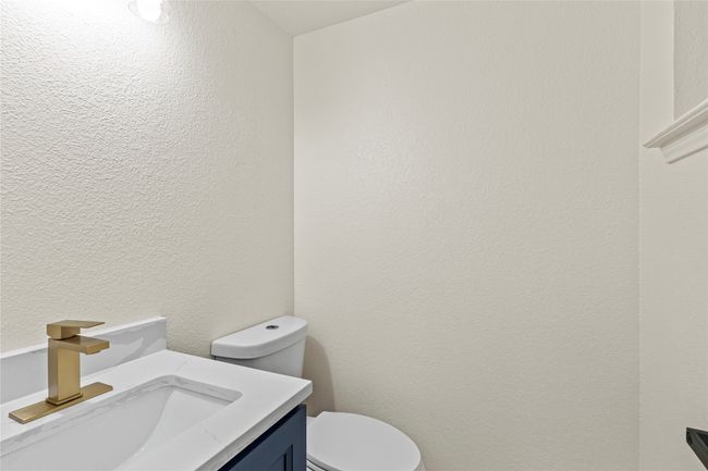 Half bathroom with vanity and a textured wall | Image 12