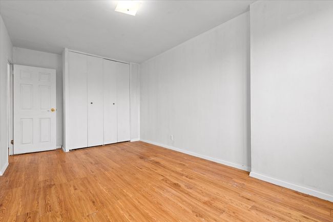 Unfurnished bedroom with light wood-style flooring, a closet, and baseboards | Image 11