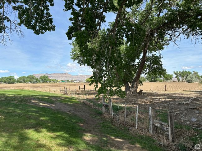 View of yard featuring a rural view, fence, and a mountain view | Image 13