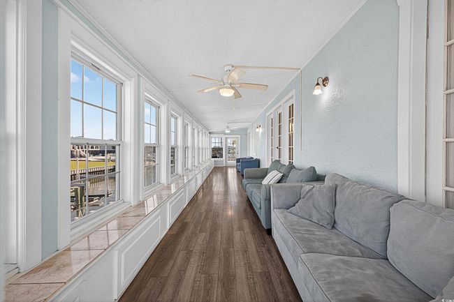 Sunroom / solarium with wood finished floors and french doors | Image 24