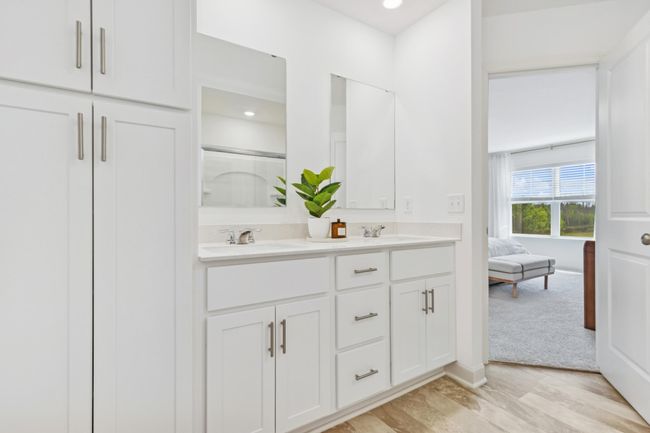 (Photo of decorated model, actual home's finishes will vary) An extension of the primary suite, this private and spacious bath contains a double vanity and a separate shower. | Image 11