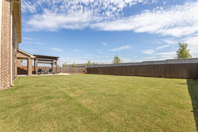 Fenced backyard with a patio | Image 40