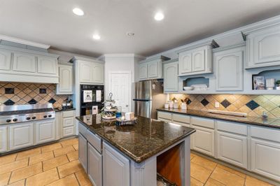 The kitchen has a large pantry to store all of your food and appliances | Image 3