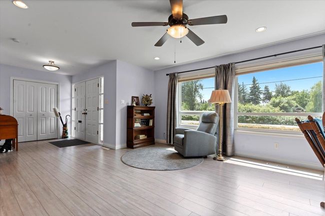 Living area featuring wood finished floors, ceiling fan, and recessed lighting | Image 13