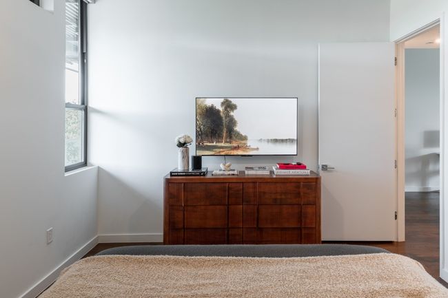 Bedroom with wood finished floors, baseboards, and multiple windows | Image 15