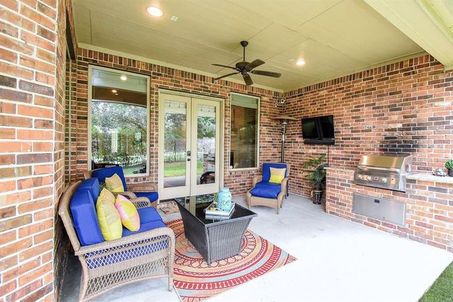The outdoor patio boasts of a ceiling fan and recessed lights! | Image 37