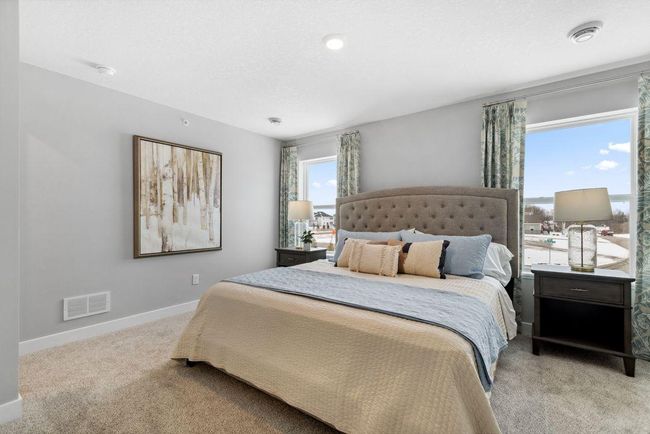 An oasis of its own, the primary suite offers the perfect escape. There's immediate access to a private bathroom that features dual sinks and a large shower. Photo is of model home. Colors and options may vary. Ask Sales Agent for details. | Image 24