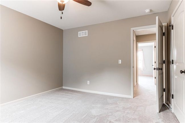 Spare room with ceiling fan and light carpet | Image 37