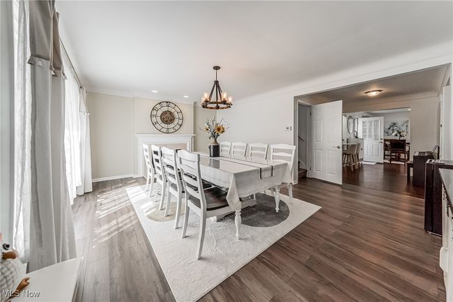 Dining room with baseboards, dark wood-style floors, and an inviting chandelier | Image 7
