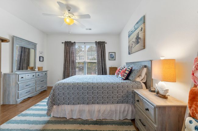 Bedroom with wood finished floors and ceiling fan | Image 20