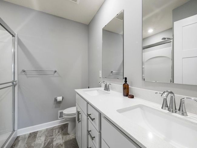 The attached ¾ private bathroom includes a walk-in shower, a spacious double vanity, and a linen closet for added organization. | Image 17