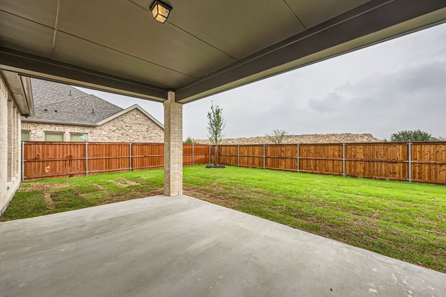 View of patio with a fenced backyard | Image 26