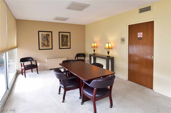 Dining space with visible vents, light colored carpet, and baseboards | Image 28