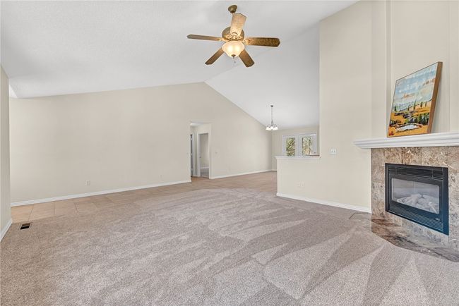 Gas log fireplace uses propane. Hallway door leads to Master BR, laundry room and garage. | Image 9