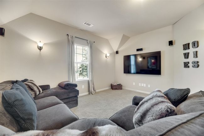 Cinema room with vaulted ceiling and carpet floors | Image 26
