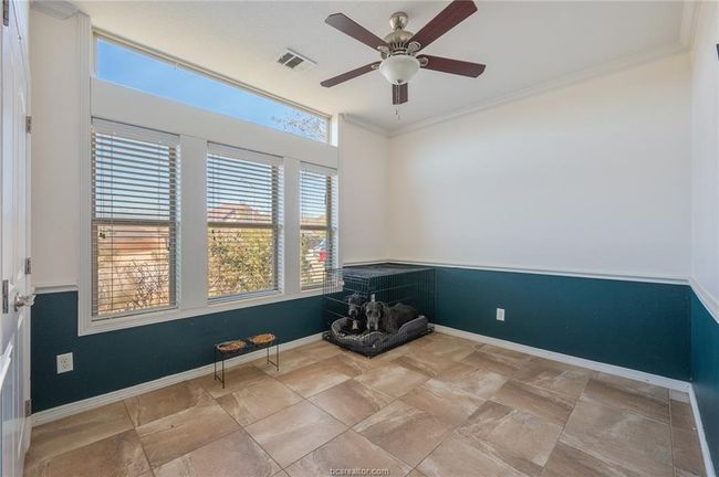 Spare room featuring ceiling fan and ornamental molding | Image 21