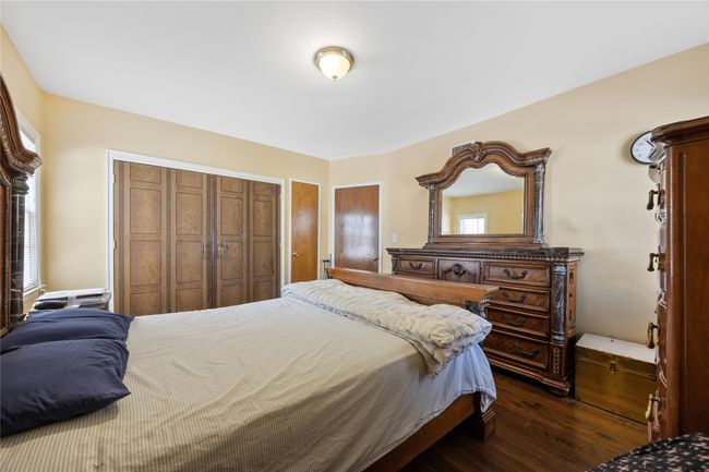 Bedroom featuring dark wood-style flooring and a closet | Image 8