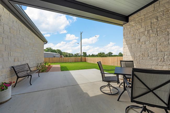 Fenced backyard with outdoor dining area and a patio area | Image 37