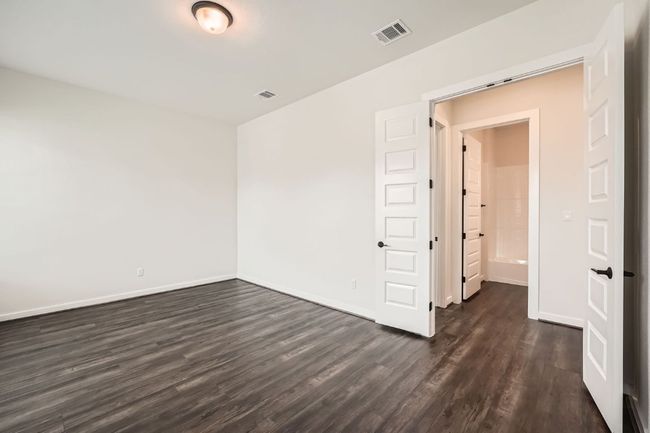 Spare room with dark wood-style flooring and baseboards | Image 12