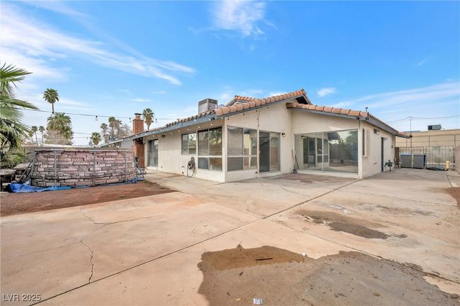 Back of house featuring stucco siding, fence, a patio area, and a tile roof | Image 22