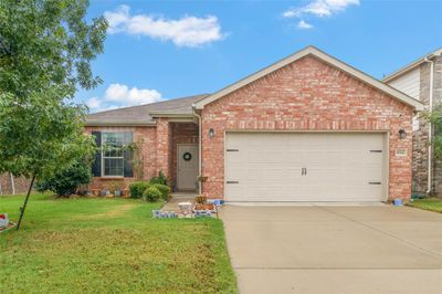 View of front of property featuring a garage and a front lawn | Image 2