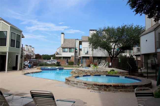 View of pool with a patio area, a pool with connected hot tub, and fence | Image 21