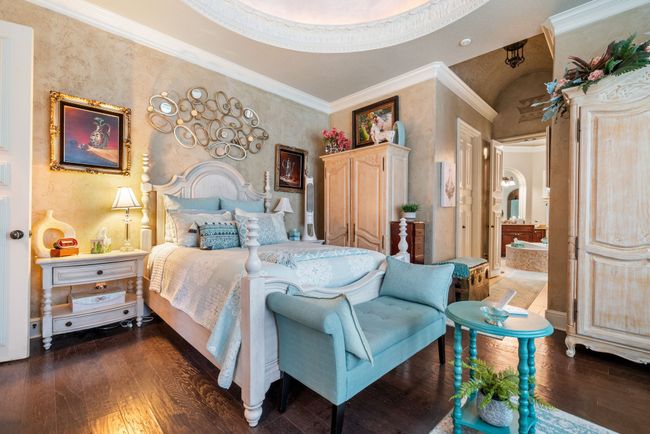 Bedroom with wood finished floors and crown molding | Image 23