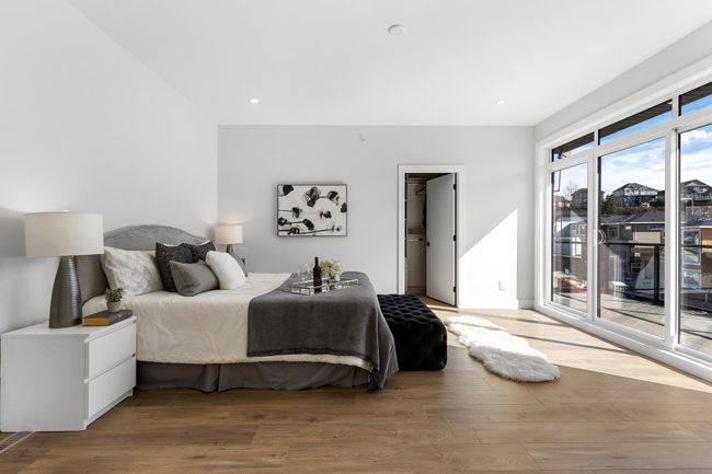 Bedroom with access to exterior, wood finished floors, and recessed lighting | Image 15