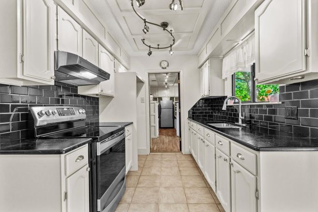 A stainless-steel range and matching range hood give the space a simple, updated look that blends with any décor. | Image 11