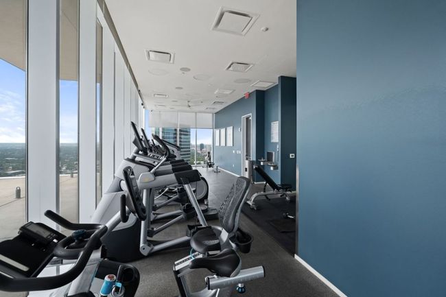Exercise room featuring a wall of windows and plenty of natural light | Image 37