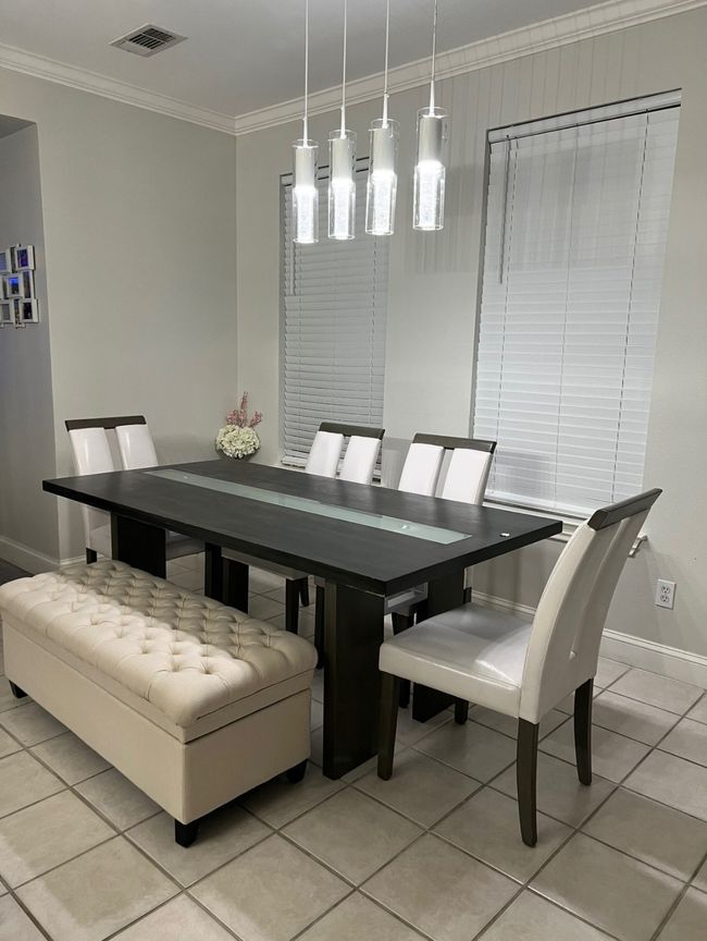 Dining room featuring light tile patterned floors and ornamental molding | Image 17