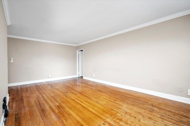 Unfurnished room with ornamental molding and light wood-type flooring | Image 6