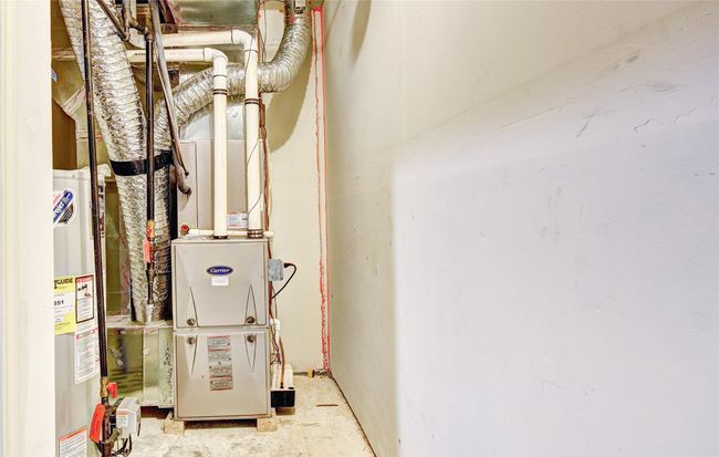 Utility room featuring water heater and furnace | Image 31