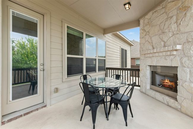 Gorgeous outdoor fireplace on raised cement deck. Private yard. Extended cement patio around back and sides of home. Great space for entertaining! | Image 29