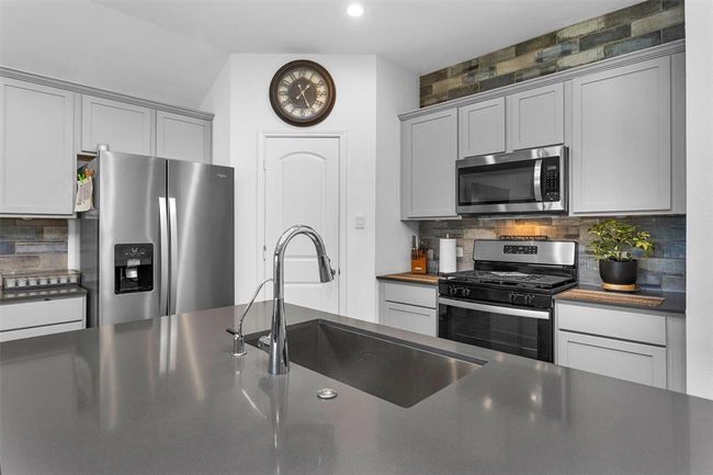 Beautiful quartz countertops in this gourmet kitchen. | Image 12