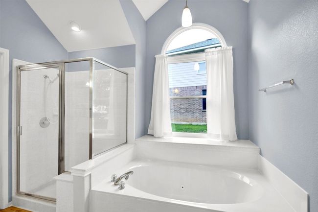 Luxury master bathroom featuring a shower stall and a tub with jets | Image 30