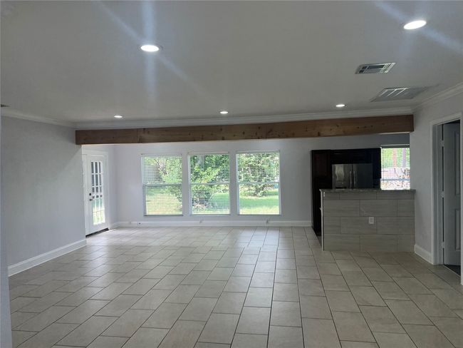 Unfurnished living room with ornamental molding, light tile patterned floors, and recessed lighting | Image 5