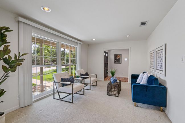Large living area off the foyer is flooded with natural light through the picture window | Image 10