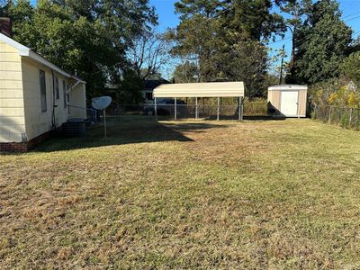 View of yard featuring a shed and a carport | Image 3