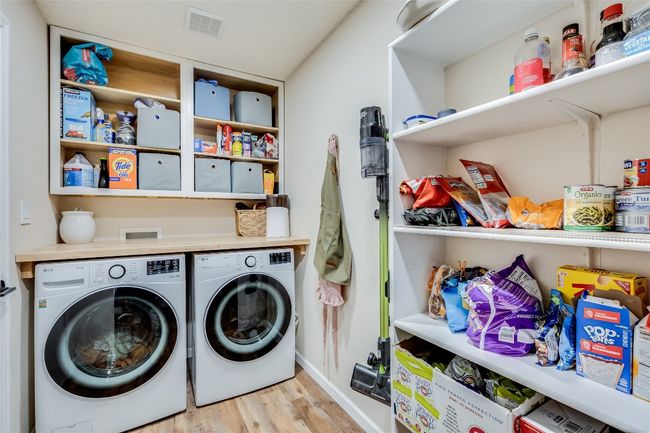 Washroom featuring washer and dryer, light wood finished floors, and baseboards | Image 25