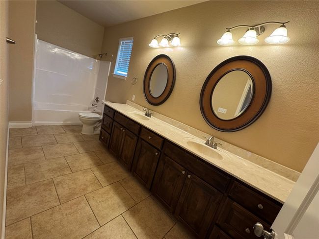 2 Full bath featuring a sink, shower / bathing tub combination, double vanity, and tile patterned flooring | Image 16