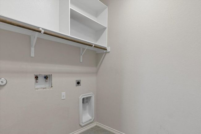 Laundry room featuring hookup for an electric dryer, hookup for a washing machine, and tile patterned floors | Image 20