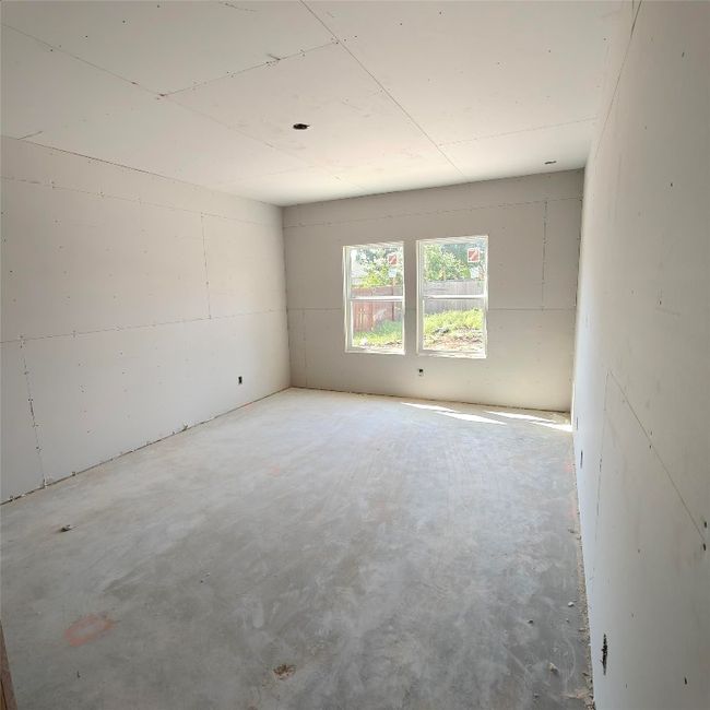 Empty room with unfinished concrete floors | Image 6