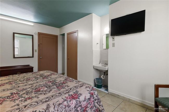 Bedroom with light tile patterned floors and baseboards | Image 7