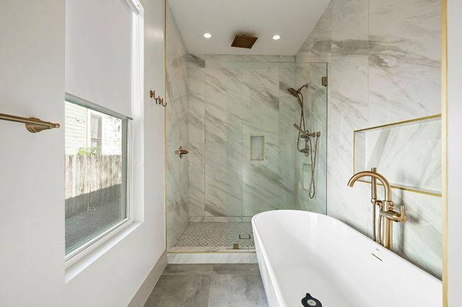 Bathroom featuring a freestanding bath, a shower stall, and recessed lighting | Image 20
