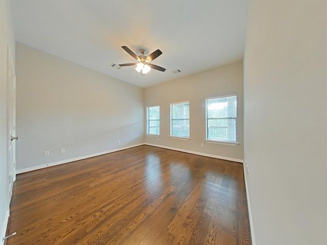 Spacious upstairs bedroom offering comfort and privacy. | Image 26